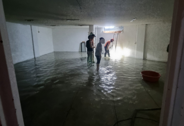 호우경보가 발령된 16일 오후 부산 수영구 한 건물 지하에 물이 차 소방당국이 배수 작업을 벌이고 있다. 연합뉴스