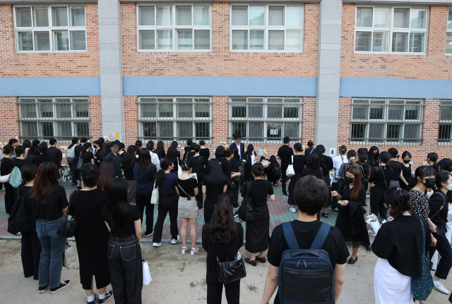 20일 오후 서울 서초구 서이초등학교에 마련된 임시 추모공간에서 추모객들이 고인이 된 교사 A씨를 추모하고 있다. 교육계에 따르면 이 학교 담임 교사 A씨가 학교 안에서 극단적 선택을 해 숨지는 일이 발생했다. 연합뉴
