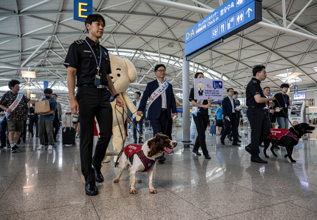 25일 인천국제공항 제1여객터미널 출국장에서 개회한 관세청 23년 상반기 마약단속 동향 발표 및 마약류 밀반입 예방 캠페인에서 관세청 직원이 탐지견과 마약탐지 시범을 보이고 있다. 영종도=권욱 기자 2023.07.25