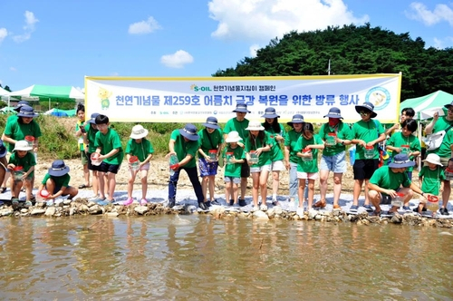 에쓰오일 직원 가족들이 지난 19일 충남 금산군 부리면 금강 하천변에서 어름치 치어 방류 활동과 하천 생태체험을 하고 있다. 사진제공=에쓰오일