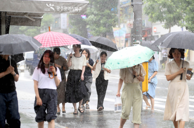 지난 29일 광주 북구청 광장에서 구청 공직자들이 우산을 쓰고 길을 지나고 있다. 사진제공=광주 북구