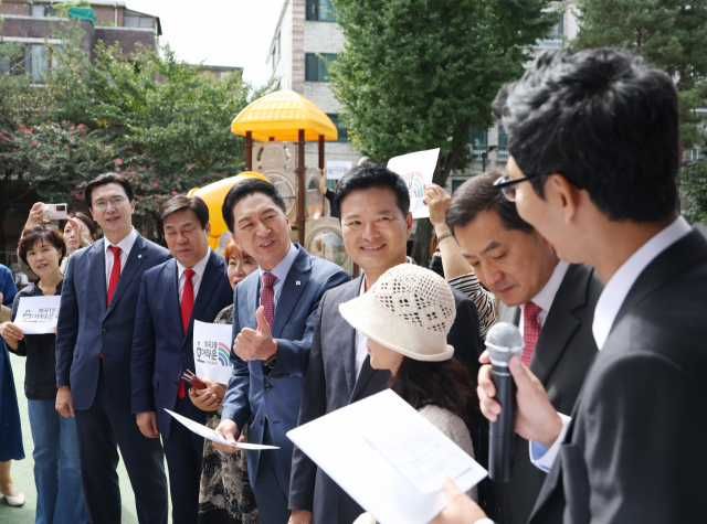 국민의힘 김기현 대표와 김태우 강서구청장 보궐선거 후보가 21일 강서구 화곡동 모아타운 예정지를 찾아 설명을 듣고 있다. 연합뉴스