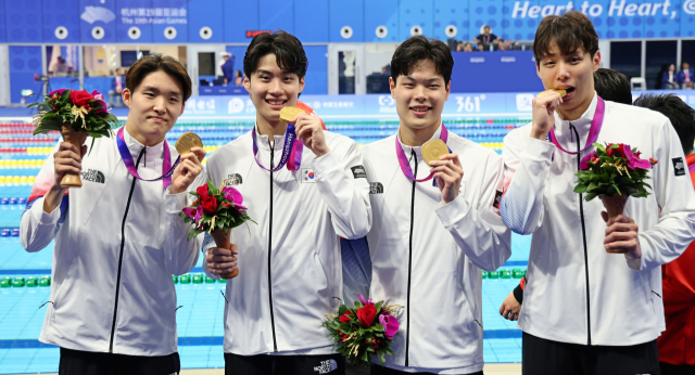 김우민(왼쪽부터)과 황선우, 이호준, 양재훈이 25일 항저우 아시안게임 수영 남자 800m 계영 시상식에서 금메달을 들어 보이고 있다. 연합뉴스