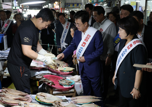 김태흠(오른쪽 두번째) 충남도지사가 서산동부전통시장을 찾아 수산식품을 구입하고 있다. 사진제공=충남도