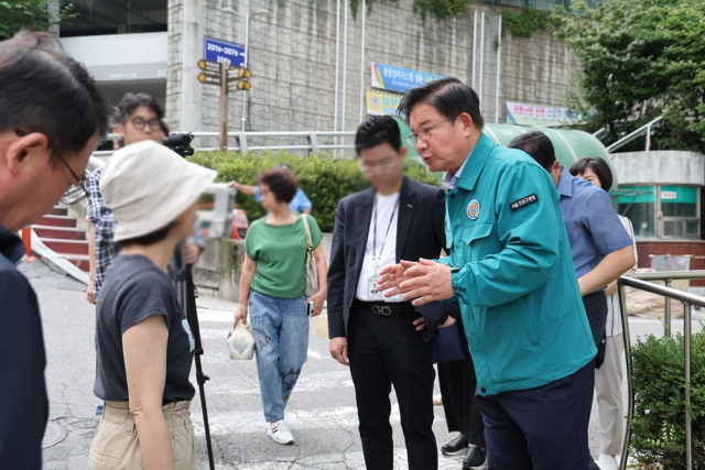 박강수 마포구청장이 아파트 관계자와 인근 주민들에게 땅꺼짐에 대한 위험성을 알리고 있다. 사진 제공=마포구청