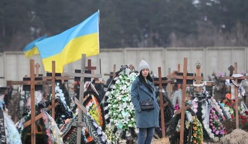2023년 1월 8일(현지시간) 우크라이나 부차의 한 공동묘지에 민간인 희생자의 가족이 고인을 추모하고 있다. 연합뉴스
