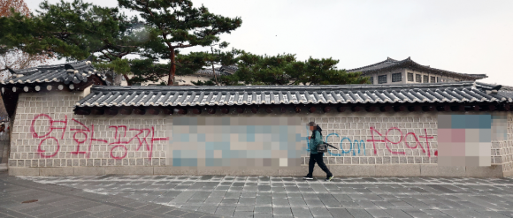 16일 오전 서울 종로구 국립고궁박물관 방향 경복궁 서쪽 담벼락에 붉은색과 푸른색 스프레이로 낙서가 적혀있다. 연합뉴스