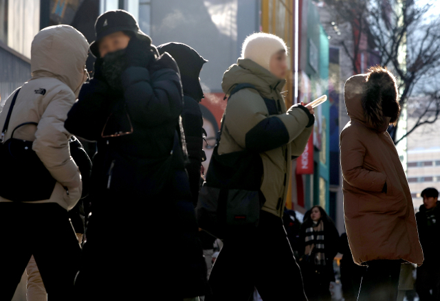 서울 최저 기온이 영하 10도 아래로 떨어진 17일 서울 명동거리에서 시민 및 관광객들이 입김을 내뿜으며 걸어가고 있다.연합뉴스