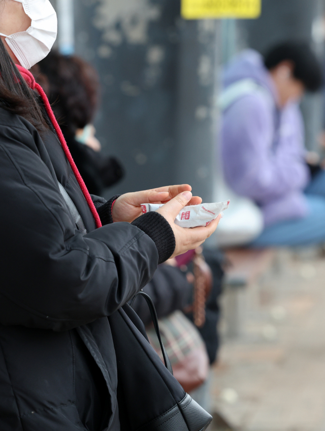 19일 오후 광주 한 버스터미널 앞에서 두꺼운 옷을 입은 시민이 따뜻한 온기가 있는 핫팩을 손에 쥐고 있다. 연합뉴스