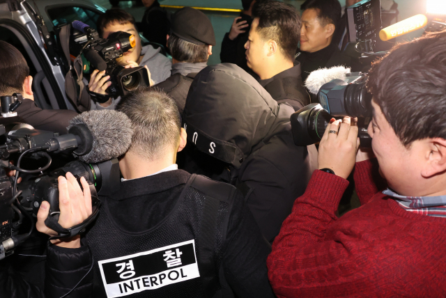26일 중국에서 국내로 송환된 강남 마약음료 피의자가 인천국제공항으로 입국해 경찰 차량에 탑승하고 있다. 연합뉴스