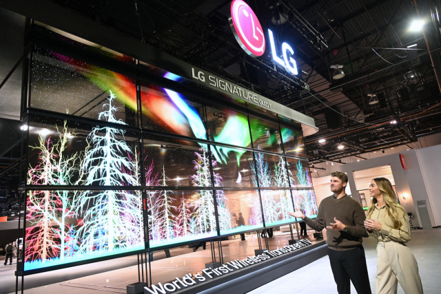 LG전자가 7일(현지 시간) 미국 라스베이거스에서 열린 ‘CES 2024’에서 세계 최초로 공개한 투명 유기발광다이오드(OLED) TV인 ‘LG 시그니처 올레드 T’를 관람객들이 지켜보고 있다. 사진 제공=LG전자