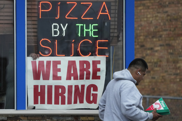 FILE - A hiring sign is displayed at a restaurant in Prospect Heights, Ill., on April 4, 2023. The government is expected to report, Thursday, Jan. 11, 2024, that underlying inflationary pressures eased further in December. (AP Photo/Nam Y. Huh, File) FILE PHOTO