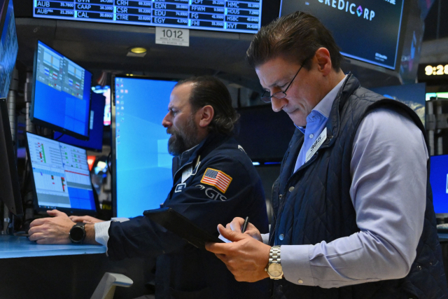 Traders work on the floor of the New York Stock Exchange (NYSE) during morning trading on January 11, 2024 in New York City. Consumer inflation in the United States rose more than anticipated in December, government data showed Thursday, with President Joe Biden conceding he must do more to tackle high prices (Photo by ANGELA WEISS / AFP)