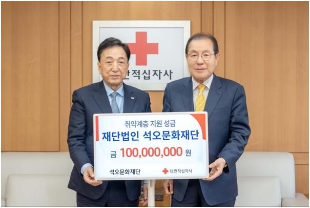 윤동한(오른쪽) 석오문화재단 이사장이 이달 26일 서울 중구 대한적십자사 서울사무소에서 성금 1억 원을 전달한 뒤 김철수 대한적십자사 회장과 기념사진을 촬영하고 있다. 사진 제공=한국콜마