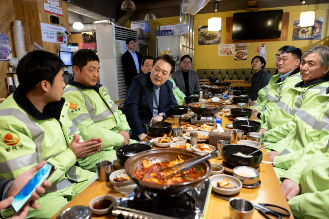 윤석열 대통령이 설 연휴 첫날인 9일 서울 동작구 한 식당에서 동작구 소속 가로청소 환경공무관들과 아침식사를 함께 하며 이야기를 나누고 있다. 연합뉴스