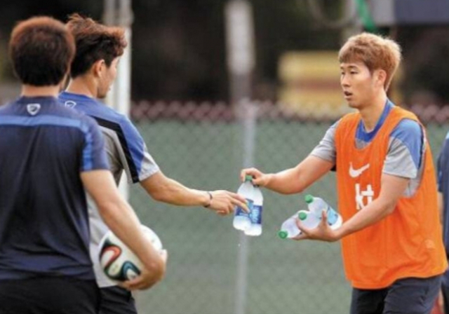 손흥민 선수가 국가대표 막내시절 선배들에게 생수를 나눠주고 있는 모습. 사진=온라인 커뮤니티