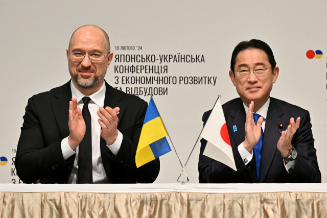 기시다 후미오(오른쪽) 일본 총리와 데니스 슈미할 우크라이나 총리가 19일 일본 도쿄에서 진행된 '일-우크라 경제부흥 추진회의'에서 우크라이나 재건 사업과 관련한 논의를 하고 있다./로이터 연합뉴스