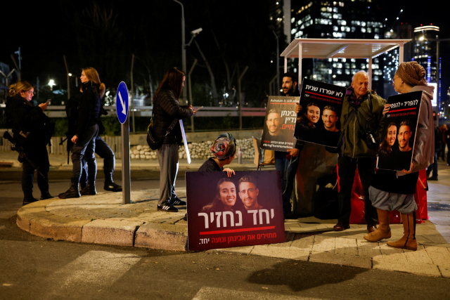4일(현지시간) 이스라엘 텔아비브에서 열린 시위에서 시위대들이 팔레스타인 무장정파 하마스가 가자 지구에서 지난해 10월 7일 납치한 인질들의 사진이 담긴 플래카드를 들고 있다. 로이터연합뉴스