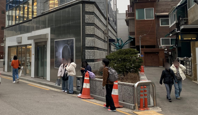 외국인 관광객들이 10일 서울 마포구 합정동의 YG엔터테인먼트 사옥 앞을 찾아 구경하고 있다. 김남명 기자