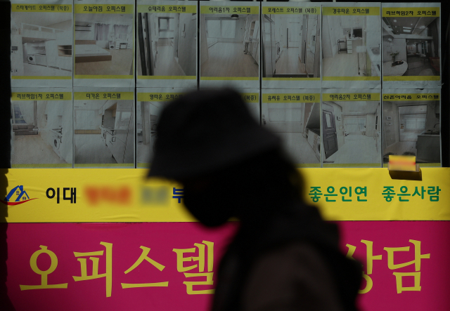 한 시민이 17일 오후 서울 시내 한 부동산 중개업소 앞을 지나가고 있다. 연합뉴스