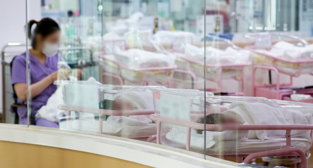 2월 28일 오후 서울 시내의 한 산후조리원 신생아실에서 한 간호사가 신생아를 돌보고 있다. 연합뉴스