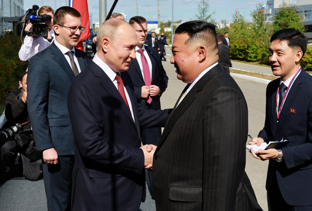 블라디미르 푸틴 러시아 대통령(왼쪽)이 2023년 9월 13일 아무르 지역의 보스토치니 코스모드롬에서 김정은 북한 국무위원장과 회담 중 악수를 나누고 있다. AFP연합뉴스