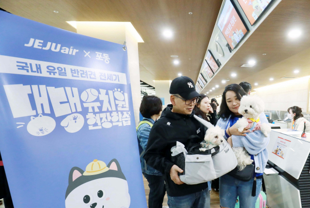 LG유플러스와 제주항공, 한국관광공사가 마련한 반려견 동반 항공 상품 '포동 전세기'의 탑승객들이 5일 김포공항 국내선 카운터에서 탑승 수속을 밟고 있다. 사진 제공=LG유플러스