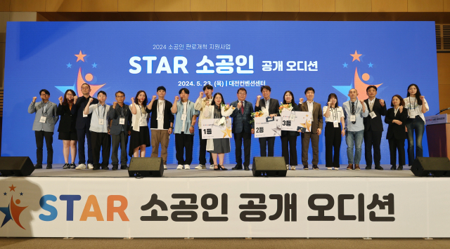 박성효(오른쪽에서 아홉번째) 소진공 이사장이 23일 대전컨벤션센터에서 개최한 ‘2024년 스타소공인 공개오디션’에서 선정된 예비 스타 소공인들과 기념사진을 찍고 있다. 사진 제공=소진공