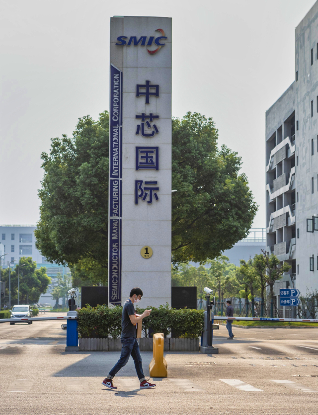 중국 최대 반도체 기업인 SMIC 로고 앞을 한 시민이 지나가고 있다. 연합뉴스