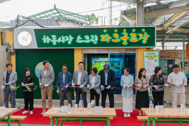 하동공설시장 안 스크린 파크골프장 개장식에 참석한 내빈들이 축하 세레머니를 하고 있다. 하동군 제공