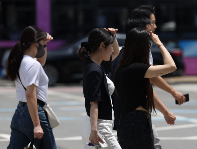 무더위가 계속 이어진 17일 서울 광화문사거리에서 시민들이 손으로 햇볕을 가리며 횡단보도를 건너고 있다. 연합뉴스