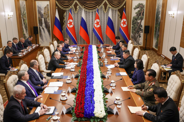 블라디미르 푸틴 러시아 대통령과 김정은 북한 국무위원장이 19일 평양 금수산 영빈관에서 확대 정상회담을 진행하고 있다. 북한은 외교·군사 분야 책임자 6명이, 러시아는 에너지·철도·교통·책임자 13명이 배석했다. AP연합뉴스