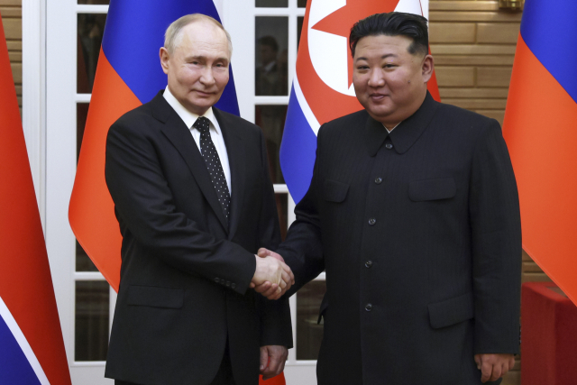 김정은(오른쪽) 북한 국무위원장과 블라디미르 푸틴 러시아 대통령이 19일 평양 금수산태양궁전 영빈관에서 열린 정상회담에서 웃으며 악수하고 있다. 두 정상은 급변하는 국제 정세 속에서 전략적 협력 의지를 한목소리로 강조했다. AP연합뉴스