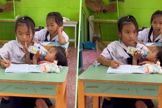 태국의 한 초등학교에서 젖먹이 동생에게 우유를 먹이면서 수업을 듣고 있는 소녀의 모습. SCMP