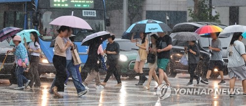 26일 오후 인천 미추홀구 터미널사거리에서 시민들이 강한 소나기에 발걸음을 재촉하고 있다. 연합뉴스