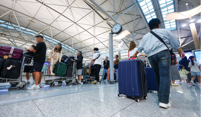 13일 오전 인천국제공항 제1여객터미널 출국장 체크인 카운터 앞에 이용객들이 줄을 서 있다. 연합뉴스