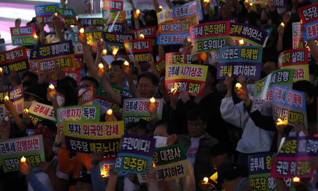 개인투자자 단체 한국주식투자자연합회가 이달 21일 서울역 앞에서 금융투자소득세 반대 촛불집회를 하고 있다. 연합뉴스