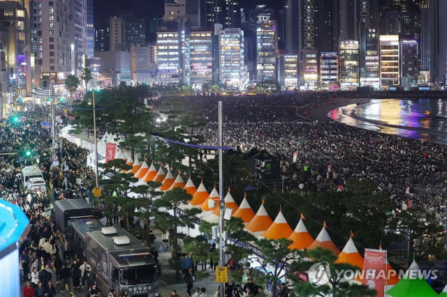 부산 시민들이 9일 수영구 광안리 해수욕장에서 열린 부산불꽃축제에 모여있다. 사진=연합뉴스