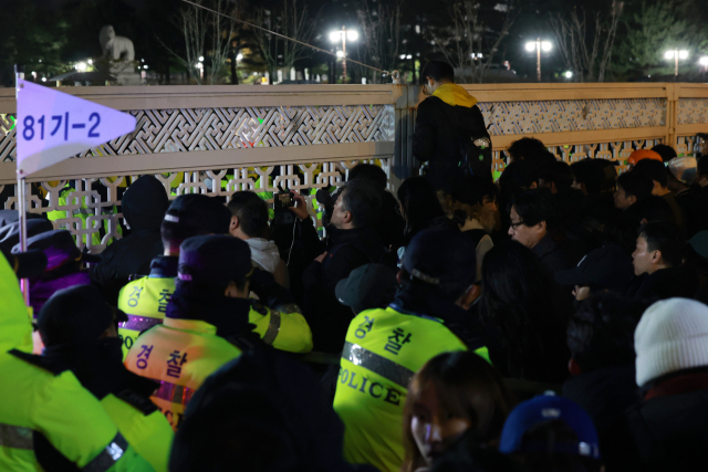 국회가 비상계엄 해제 요구 결의안을 가결한 4일 새벽 국회 앞에서 시민들이 국회 출입을 통제하는 경찰과 대치하고 있다. 연합뉴스