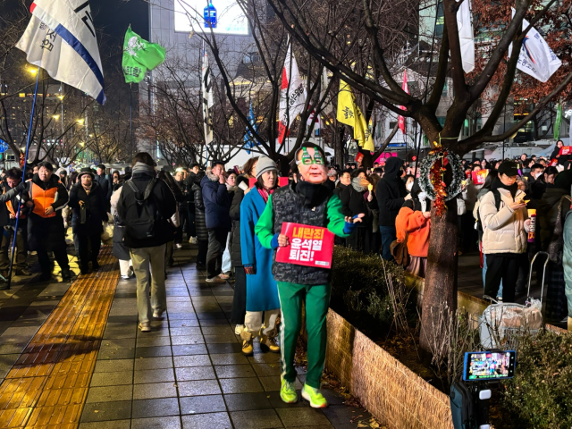 5일 ‘내란죄 윤석열 퇴진 시민대회’에 참석한 한 시민이 윤석열 대통령 가면을 쓴 채 춤을 추고 있다. 정다은 기자