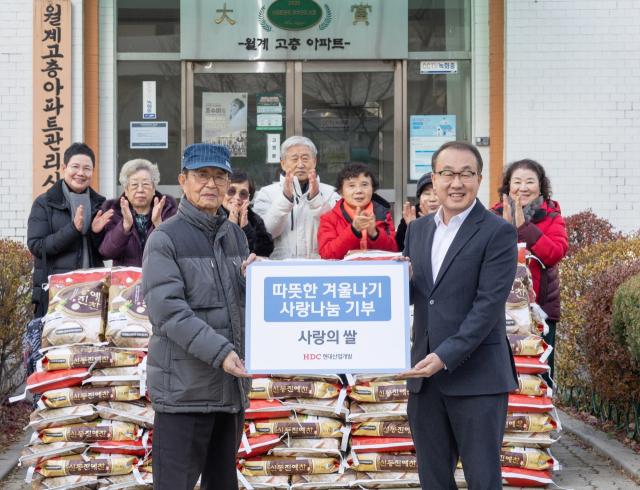 HDC현대산업개발이 지난 9일 서울시 노원구 어르신에게 식료품을 기부하는 전달식을 진행한 가운데 김욱진(앞줄 왼쪽) 월계시영고층아파트 입주자대표회장과 신왕섭 HDC현대산업개발 실장이 기념촬영을 하고 있다. 사진제공=HDC현대산업개발