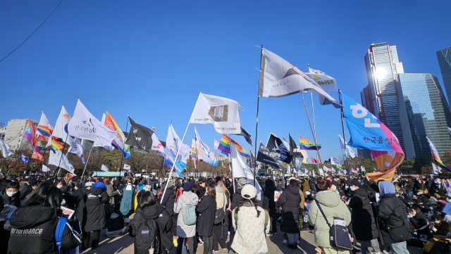 14일 여의도 공원에 모인 시민들이 깃발을 흔들고 있다. 채민석 기자