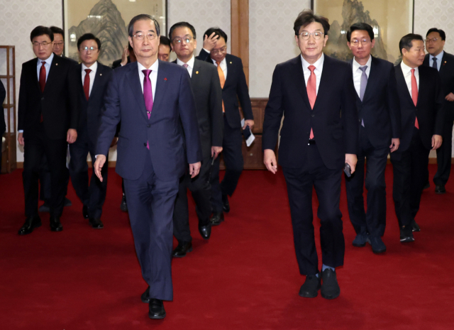 한덕수 대통령 권한대행 국무총리와 국민의힘 권성동 대표 권한대행 겸 원내대표가 20일 서울 종로구 삼청동 총리공관에서 기념촬영 후 고위당정협의회 장소로 이동하고 있다. 연합뉴스