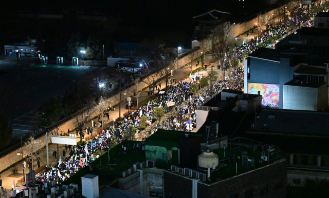 24일 서울 종로구 경복궁역 인근에서 '윤석열즉각퇴진·사회대개혁 비상행동' 주최로 열린 메리퇴진크리스마스 민주주의 응원봉 콘서트에서 시민들이 대통령 퇴진을 촉구하며 헌법재판소로 행진하고 있다. 권욱 기자