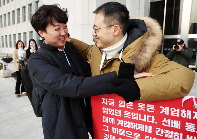 이준석 개혁신당 의원이 13일 서울 여의도 국회 본청 앞에서 윤석열 대통령 탄핵 표결 찬성을 호소중인 김상욱 국민의힘 의원과 인사를 나누고 있다. 뉴스1