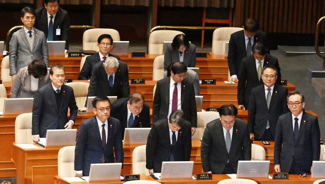 지난달 11일 한덕수 국무총리를 비롯한 국무위원들이 국회 본회의에 출석해 서영교 더불어민주당 의원의 12·3 비상계엄 사태에 대한 사과 요구에 고개 숙여 사과하고 있다. 김문수(뒷줄 왼쪽 두 번째) 고용노동부 장관은 사과 요구를 거부한 듯 자리에서 일어나지 않았다. 오승현 기자