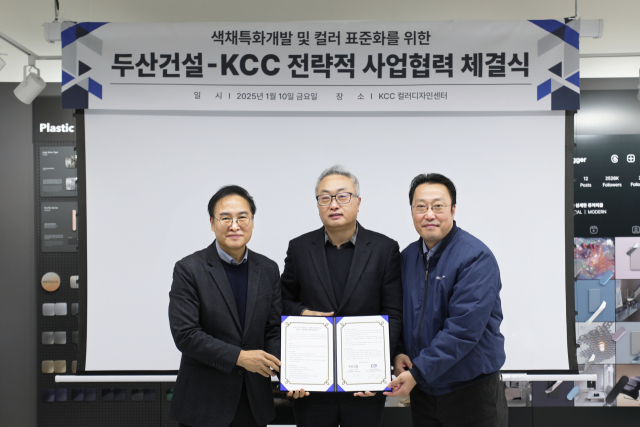 신종범(가운데) 두산건설 상무가 지난 10일 서울 서초구 서초동 KCC 컬러디자인센터에서 맹희재(맨 왼쪽) KCC 상무와 안일진(맨 오른쪽) 상무와 함께 업무협약서를 들어 보이고 있다. 사진 제공=두산건설