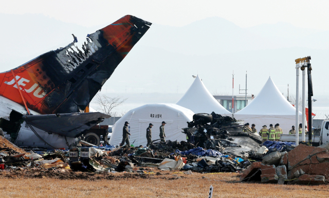 지난 14일 오전 전남 무안국제공항 사고 현장에서 수습 당국 관계자들이 수색 작업을 하고 있다. 연합뉴스