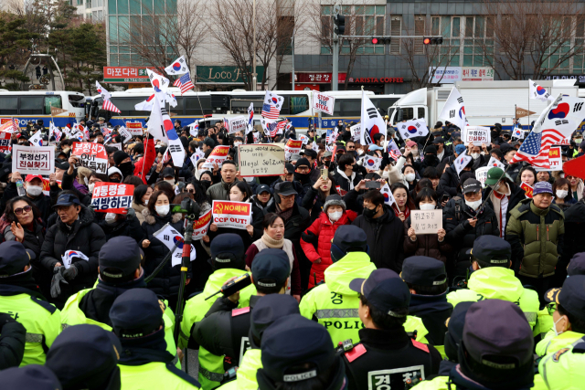 내란 우두머리 혐의로 체포된 윤석열 대통령의 구속 전 피의자심문(영장실질심사)이 열린 18일 서울 마포구 서울서부지방법원 앞에서 윤 대통령 지지자들이 집회를 하고 있다. 연합뉴스