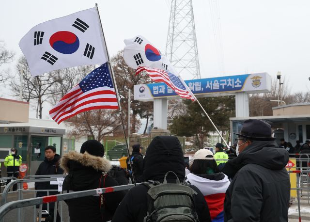 31일 오전 경기도 의왕시 서울구치소 앞에서 윤석열 대통령 지지자들이 태극기를 흔들고 있다. 연합뉴스